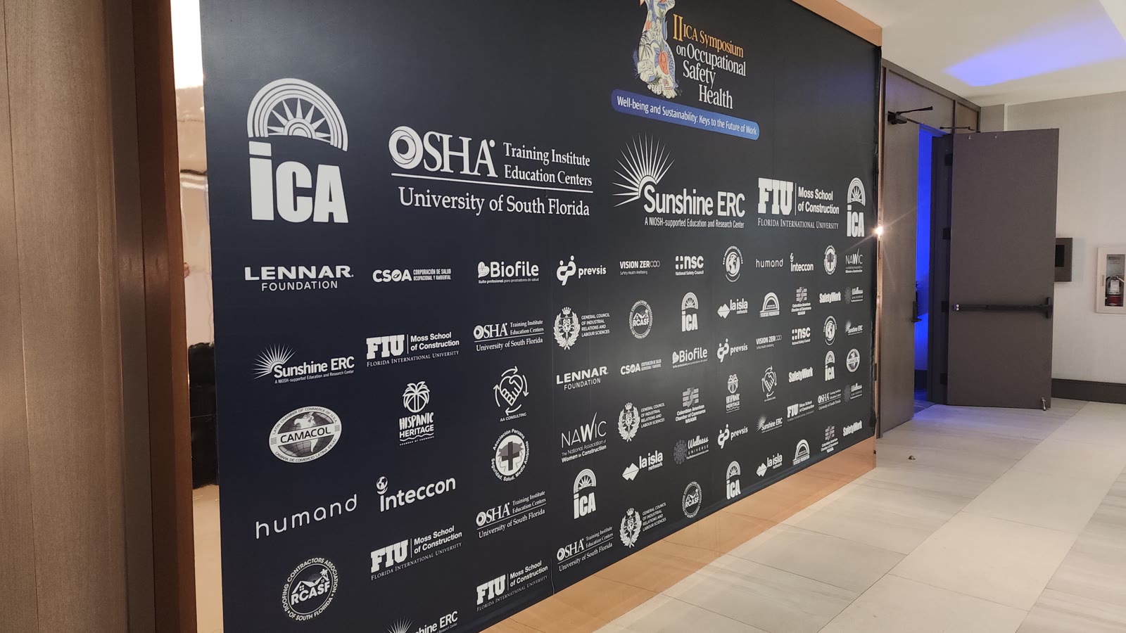 II ICA Symposium 2026 event identification at the ballroom entrance.