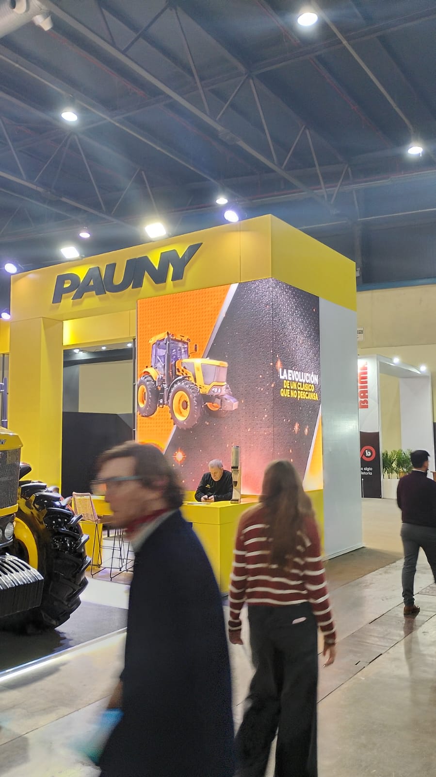 Corner LED display showing machinery inside a booth.